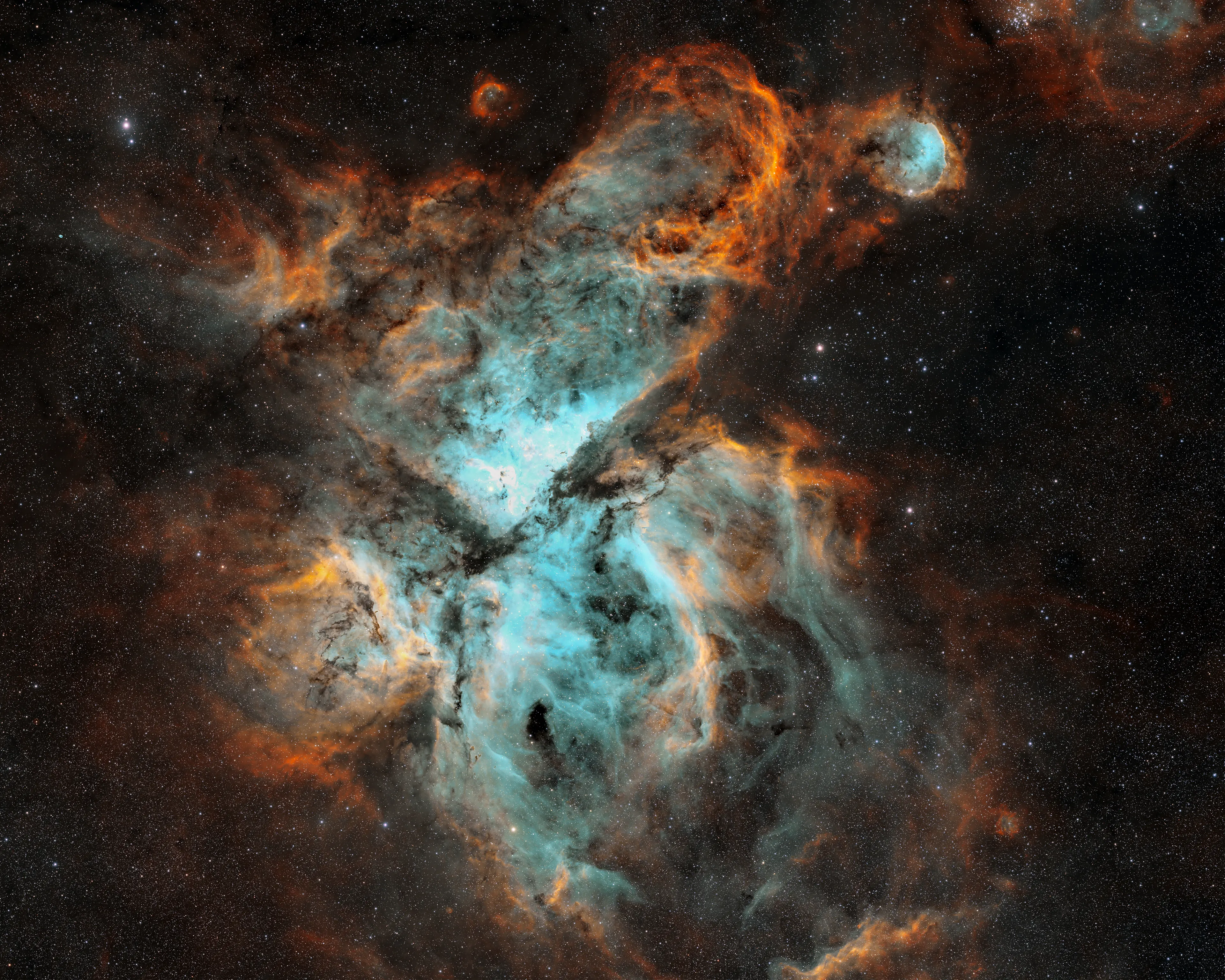 The Carina Nebula in Hubble-palette colors, with dark dust lanes across glowing gas